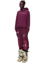Stylish purple sweatpants with "Autonomous Highway" text and paint splatter design.