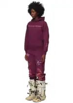 Hoodie with "Central Highway" print and splatter design, paired with rugged boots.