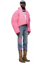Man wearing Sp5der 5Star Pink Puffer Jacket with jeans and boots.