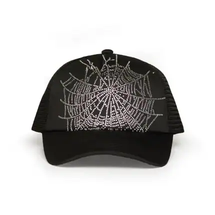 Rhinestone spider web design on black trucker cap for stylish streetwear. Perfect for fashion-forwar.