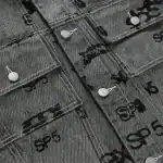 Foil print Sp5der logo on black denim trucker jacket with button closures, stylish streetwear for fa.