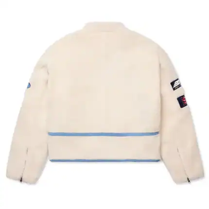 White Sherpa Moto Jacket with patches, stylish and warm for motorcycle riding.