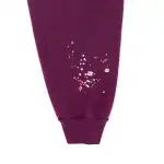 Close-up of the Sp5der Nocturnal Highway Hoodie sleeve with pink and white splatter design.