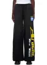 Comfortable black sweatpants with "Traci" branding and Swedish flag detail.